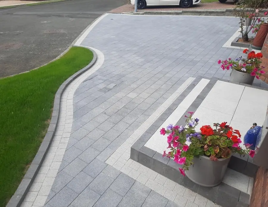 Curved block paving driveway with granite steps and flower pots