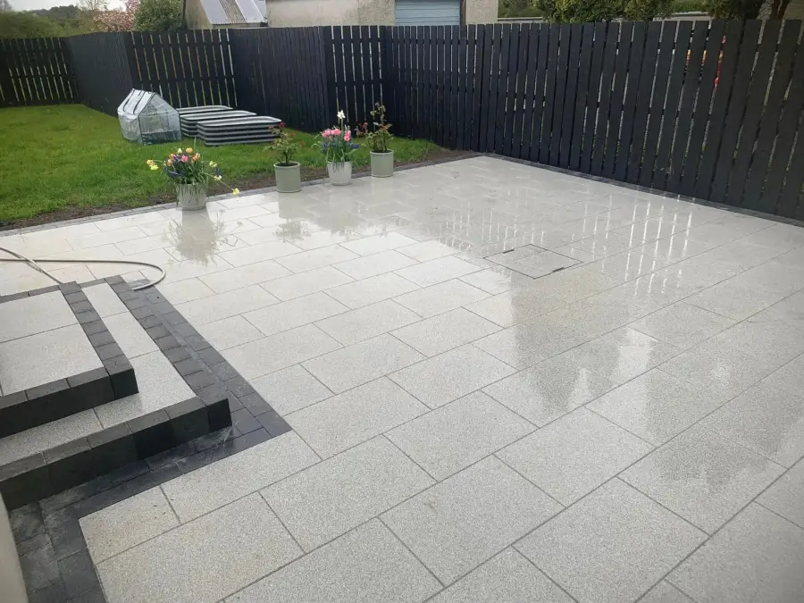 White granite patio with dark slate border steps